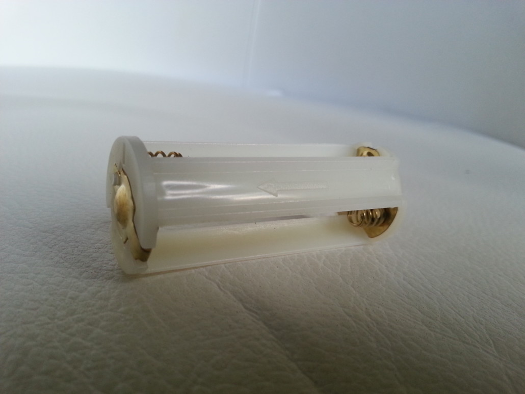 PeeDar Battery Caddy Displaying Arrow Pointing To Positive (LED) End